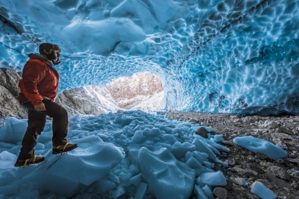 istock Hiker with crampon in ice cave - Eiskapelle Nationalpark Berchtesgaden 668036130