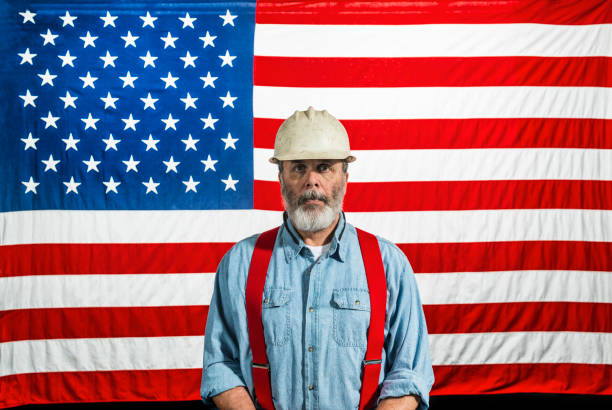 Middle-aged construction worker portrait in front of a US flag