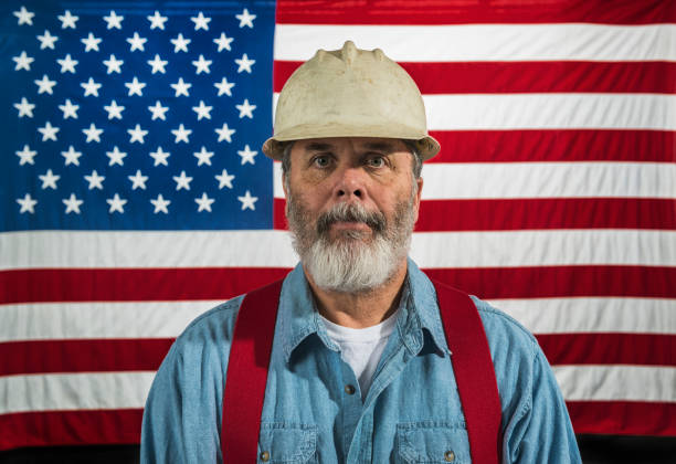 istock Middle-aged construction worker portrait in front of a US flag 668040538