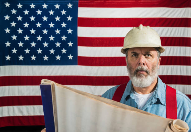 istock Middle-aged construction worker portrait in front of a US flag 668040594