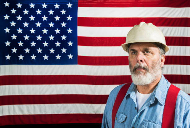 istock Middle-aged construction worker portrait in front of a US flag 668040650
