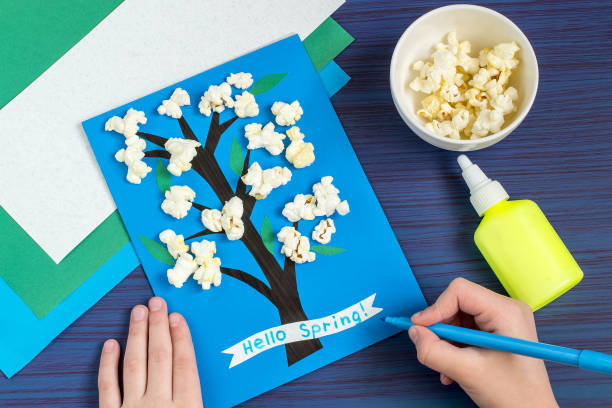 Making card by a child on spring theme. Step 7 stock photo
