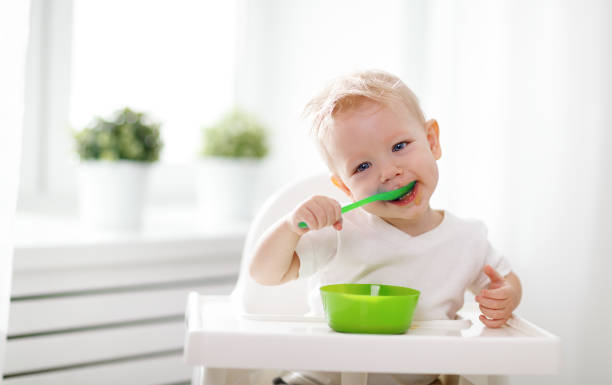 istock Happy baby eating himself 668056926