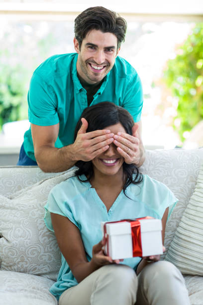 istock Man giving a surprise gift woman 668056932