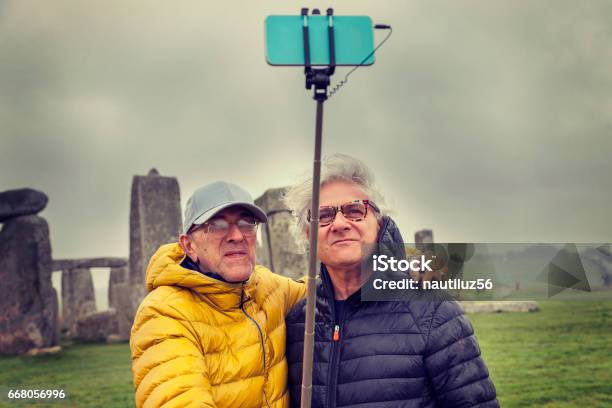 Mature Men Friends Take A Selfie In The Stonehenge Archaeological Site Stock Photo - Download Image Now