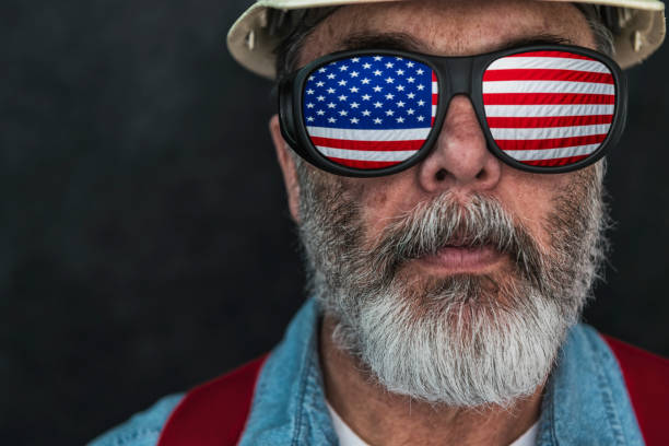 istock US flag reflecting in the eyeglasses of a construction worker 668057728