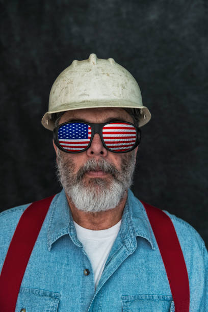 istock US flag reflecting in the eyeglasses of a construction worker 668057774