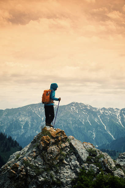 istock successful woman backpacker enjoy the view on mountain peak 668060872