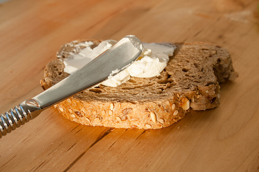 cheese spreads, knife and wholemeal bread breakfast