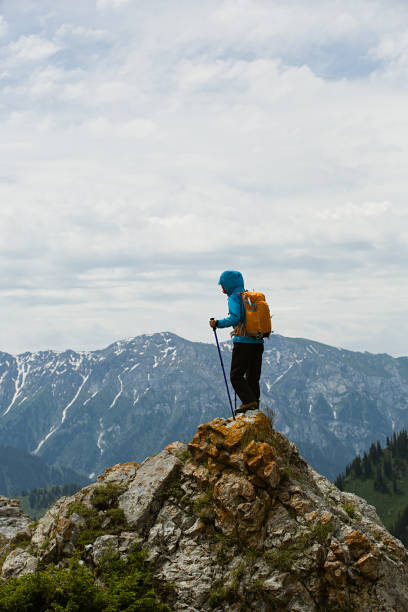 istock successful woman backpacker enjoy the view on mountain peak 668061108