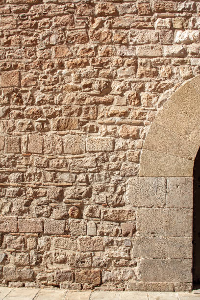 istock medieval stone wall of old building in sunny day 668067506