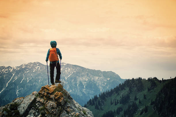 istock successful woman backpacker enjoy the view on mountain peak 668070260