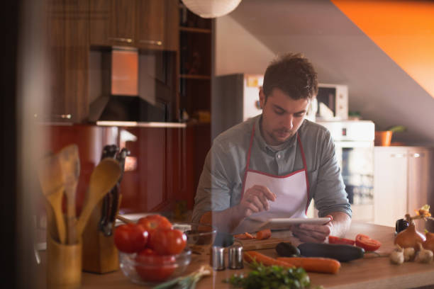 istock Young, attractive, handsome man cooking food in a kitchen 668070452