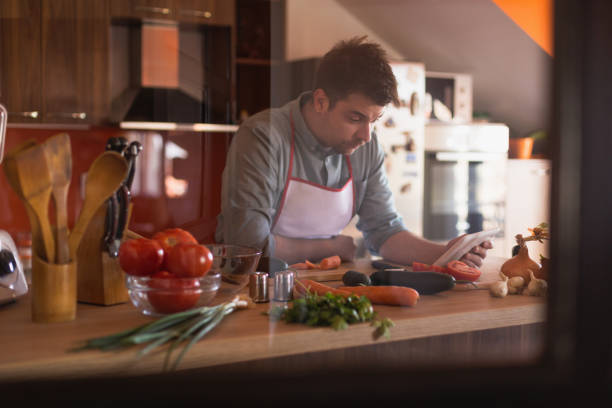 istock Attractive, handsome man cooking food in a kitchen 668070500