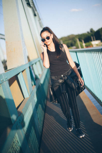 istock Young attractive girl walking over the bridge 668074106