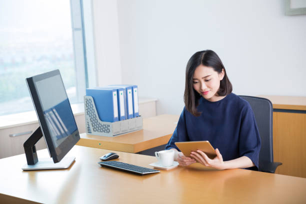 istock young beautiful girl,sitting in the office began her work 668087408