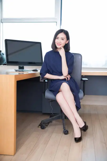 young beautiful girl,sitting in the office began her work