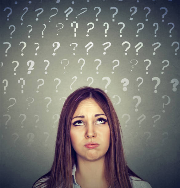 istock Upset thinking business woman looking up has many question marks 668087596