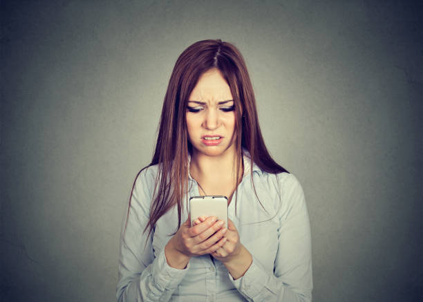 istock Upset woman looking at cellphone displeased with message she received 668087776