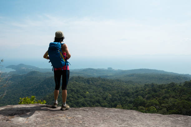 istock young woman backpacker enjoy the view on mountain peak 668093710