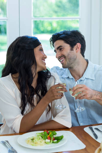 istock Couple toasting wine glasses 668096522
