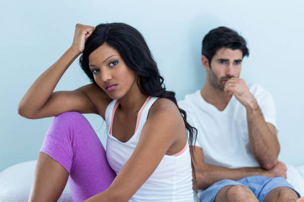 istock Upset couple ignoring each other after fight on bed 668096754