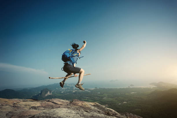 istock jumping on rocky mountain peak, freedom, risk, challenge, success concept 668099812