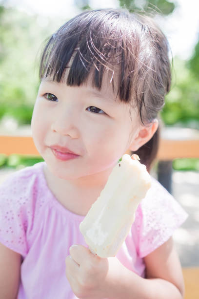 istock cute girl eat popsicle 668109662