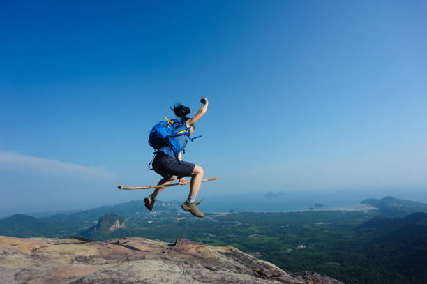 istock jumping on rocky mountain peak, freedom, risk, challenge, success concept 668109772