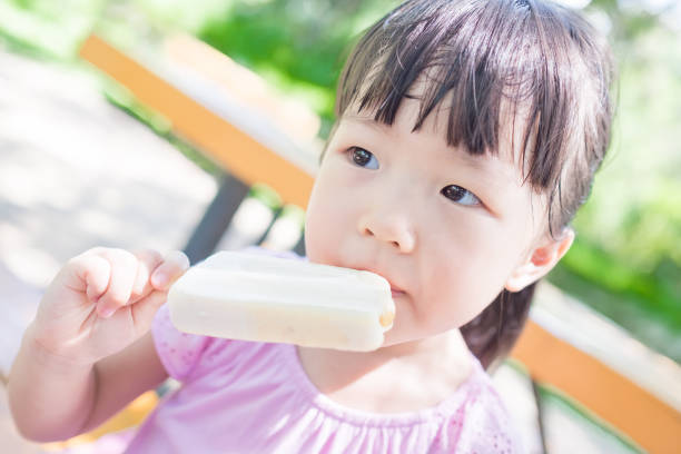 istock cute girl eat popsicle 668109780