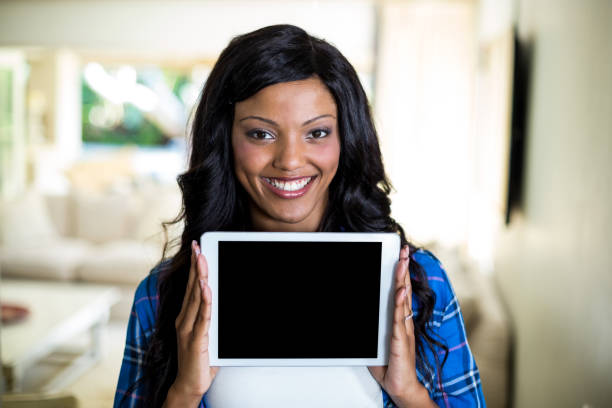 istock Young woman showing digital tablet 668110368