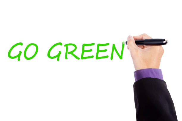istock Businessman hand writes Go Green text 668120430