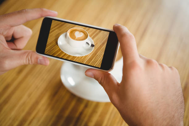 istock A man taking a photo of a coffee 668123660