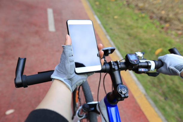 istock closeup of hands use gps navigator on cellphone while biking 668124370