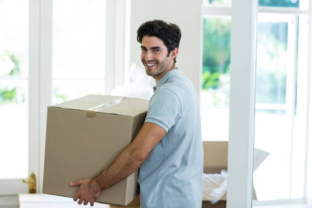 istock Young man carrying cardboard box 668125226