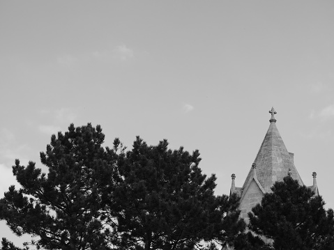 Monochrome view of cross church detail and roof outdoors