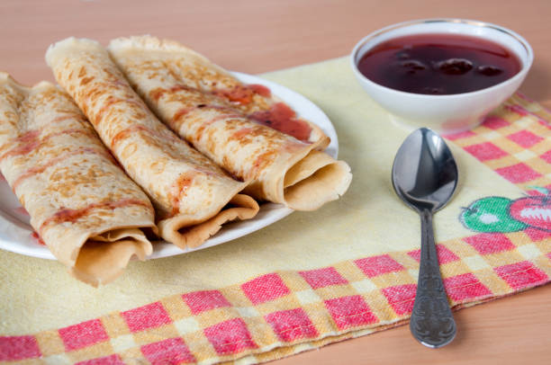 Delicious pancakes on a plate with strawberry jam