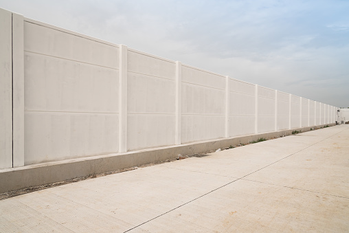 Prefabricated concrete fence isolated on sky background.