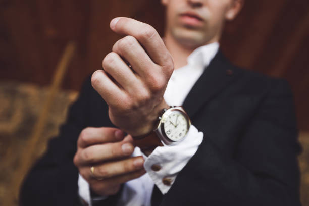 Man in black suit wear new watches. Luxury style stock photo