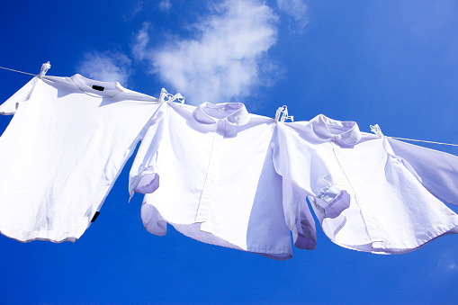 Laundry drying on rotary dryer on a sunny day in England.