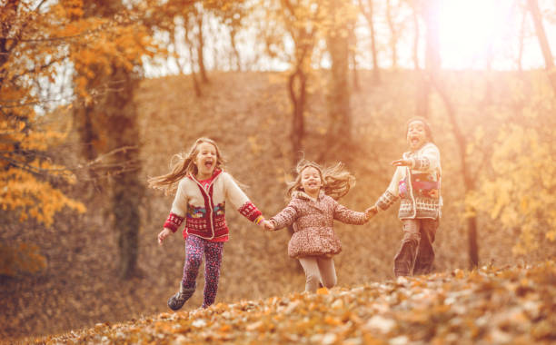 istock Joyful friends running in the park and screaming. 668143772