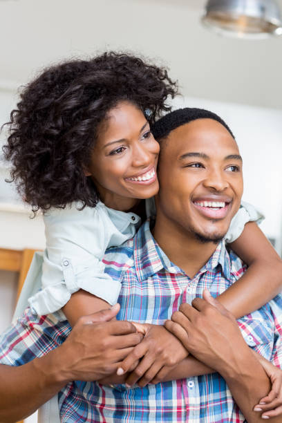 istock Young couple embracing each other in kitchen 668144360