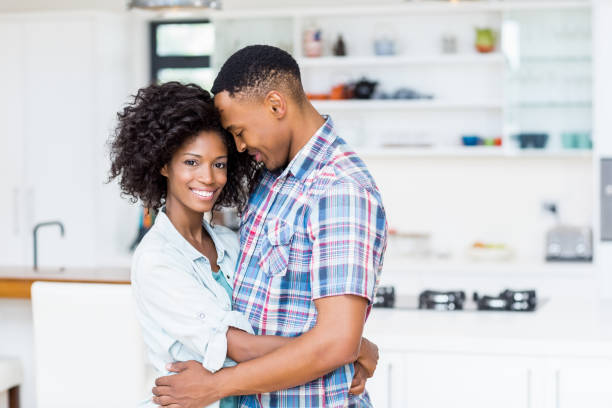 istock Young couple embracing each other in kitchen 668147126