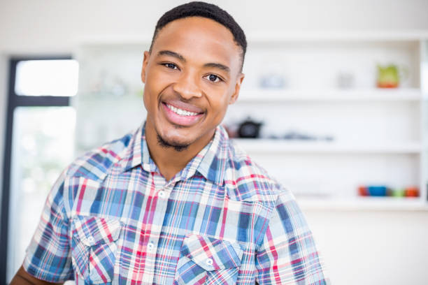istock Portrait of young man smiling at camera 668147236