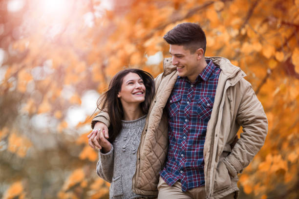 istock Young happy couple walking embraced through nature. 668147634