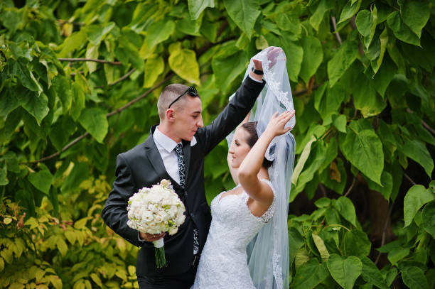 istock tender wedding couple background green leaf 668147640