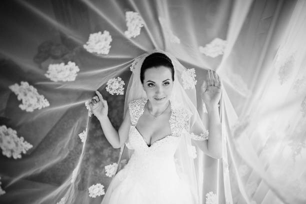 istock brunette bride at the curtains 668147758