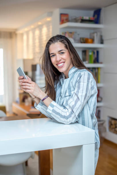 istock Young woman with phone at home 668148294
