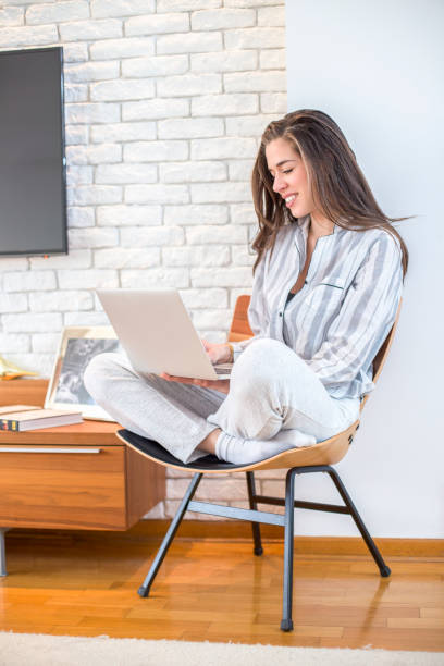 istock Young woman working on laptop at home 668150932