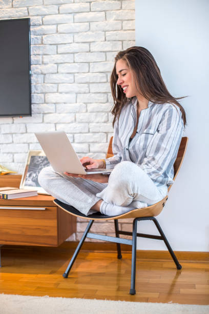 istock Young woman working on laptop at home 668151004